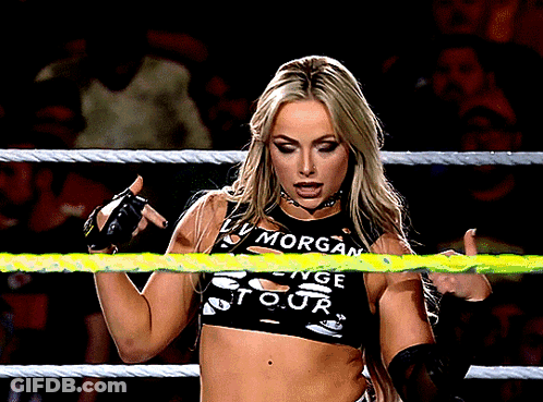 A Woman In A Wrestling Ring Wearing A Top That Says Morgan GIF