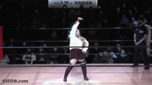 A Woman In A Wrestling Ring With A Sign Above Her That Says 2022.3.19 GIF