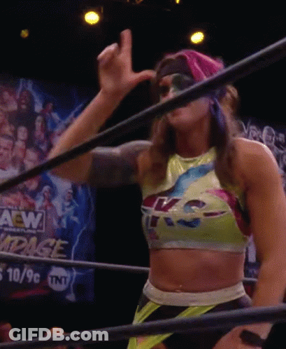 A Woman In A Wrestling Ring With A Sign That Says Aew GIF
