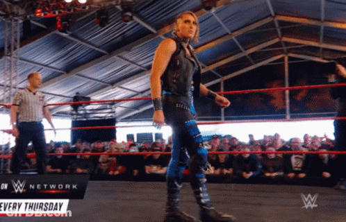 A Woman In A Wrestling Ring With A Sign That Says Network Every Thursday GIF