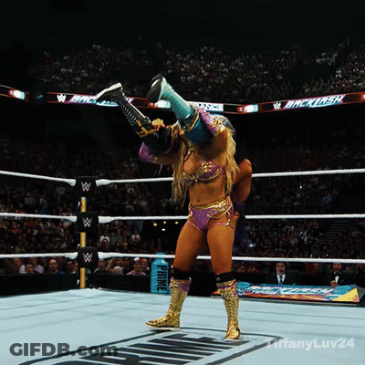 A Woman In A Wrestling Ring With A Sign That Says Prince In The Background GIF