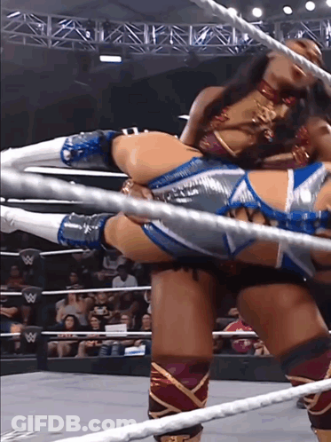 A Woman In A Wrestling Ring With A W Logo On The Ropes GIF
