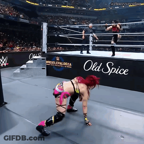 A Woman In A Wrestling Ring With An Old Spice Sign In The Background GIF