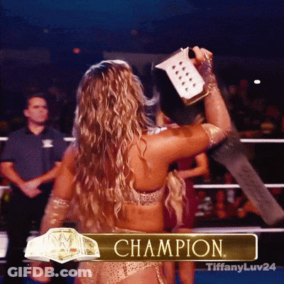 A Woman In A Wrestling Ring With The Word Champion On The Bottom GIF