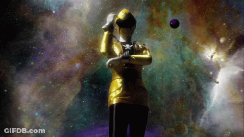 A Woman In A Yellow And Black Costume With A Skull And Crossbones On Her Chest GIF