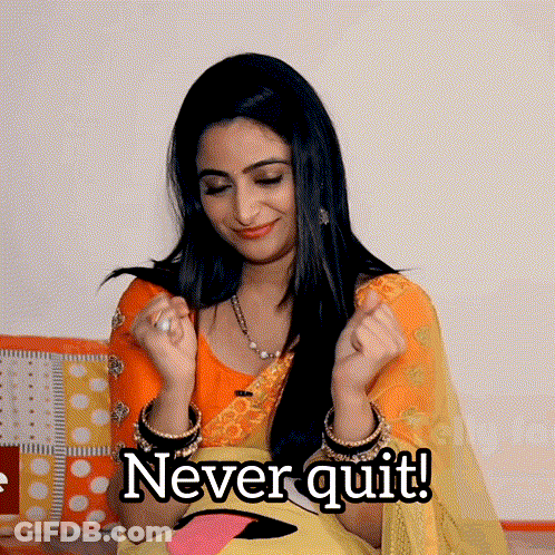 A Woman In A Yellow And Orange Dress Says " Never Quit " With Her Hands In The Air GIF