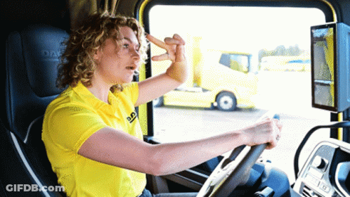 A Woman In A Yellow Daf Shirt Driving A Truck GIF