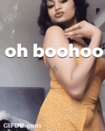 A Woman In A Yellow Dress Has The Words Oh Boohoo Written On Her Arm GIF