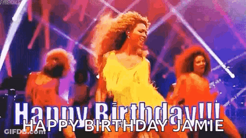 A Woman In A Yellow Dress Is Dancing On A Stage In Front Of A Group Of People . GIF