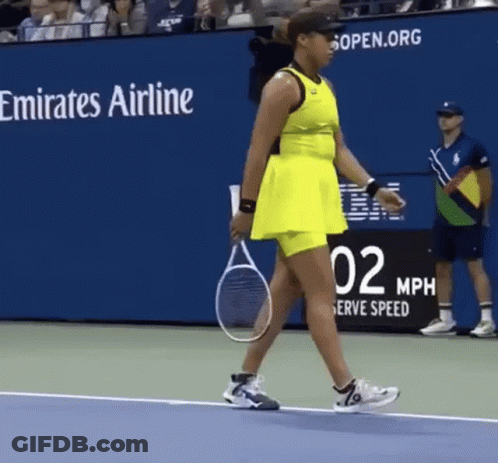 A Woman In A Yellow Dress Is Holding A Tennis Racquet On A Tennis Court .. GIF