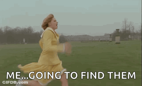 A Woman In A Yellow Dress Is Running Through A Grassy Field . GIF