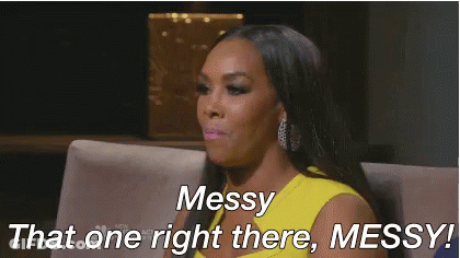 A Woman In A Yellow Dress Is Sitting On A Couch And Says Messy That One Right There Messy . GIF