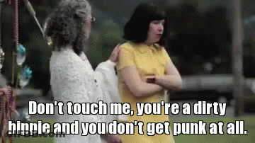 A Woman In A Yellow Dress Is Talking To Another Woman In A White Dress GIF