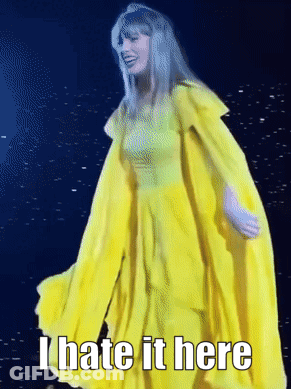 A Woman In A Yellow Dress With The Words " I Hate It Here " On The Bottom GIF