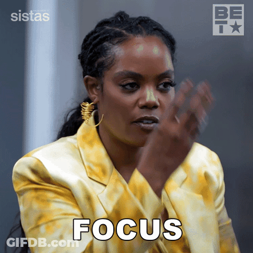A Woman In A Yellow Jacket Has The Word Focus Written On Her Face GIF