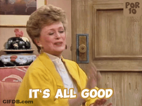 A Woman In A Yellow Jacket Says It 'S All Good In Front Of A Door GIF