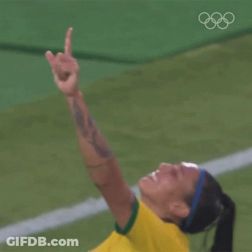 A Woman In A Yellow Shirt Is Giving A Thumbs Up Sign GIF