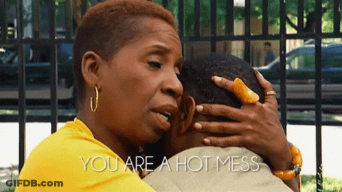 A Woman In A Yellow Shirt Is Hugging A Man With The Words You Are A Hot Mess Above Them GIF