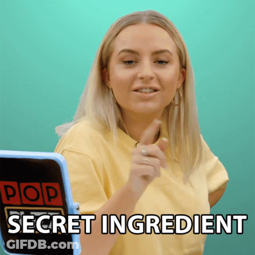 A Woman In A Yellow Shirt Is Pointing At A Screen That Says Pop Secret Ingredient GIF