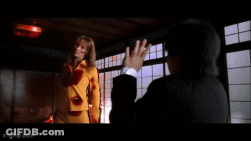 A Woman In A Yellow Shirt Is Saying Go Home To Your Mother . GIF