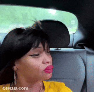 A Woman In A Yellow Shirt Is Sitting In The Back Seat Of A Car With Her Eyes Closed GIF