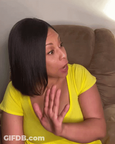 A Woman In A Yellow Shirt Is Sitting On A Couch Making A Face GIF