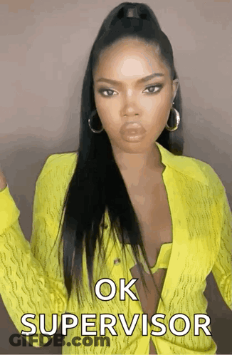 A Woman In A Yellow Shirt Says Ok Supervisor On The Screen GIF