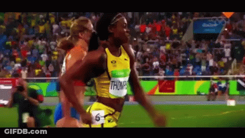 A Woman In A Yellow Shirt With The Name Thompson On It Is Running GIF
