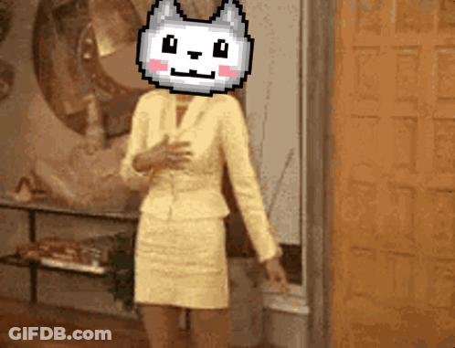 A Woman In A Yellow Suit Has A Pixelated Cat Head On Her Head GIF