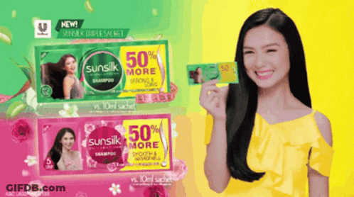 A Woman In A Yellow Top Is Holding A Sachet Of Sunsilk GIF