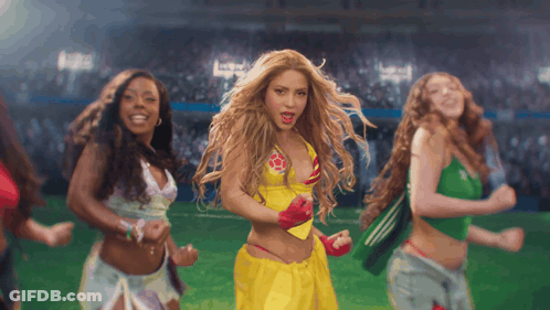 A Woman In A Yellow Top With A Red Star On It Is Dancing GIF