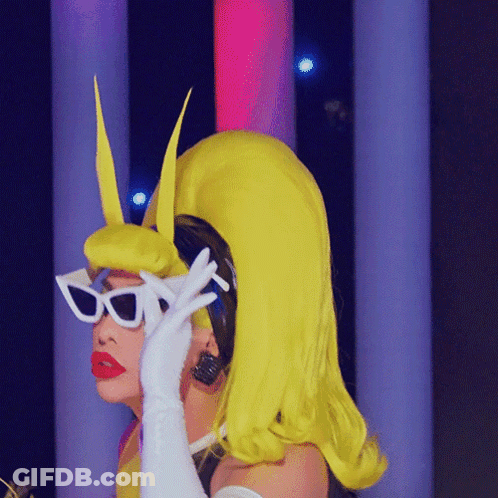 A Woman In A Yellow Wig And White Sunglasses GIF