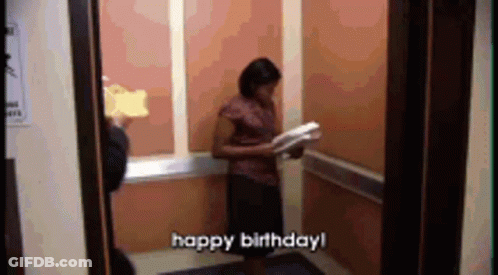 A Woman In An Elevator Is Holding A Piece Of Cake And Says Happy Birthday ! GIF