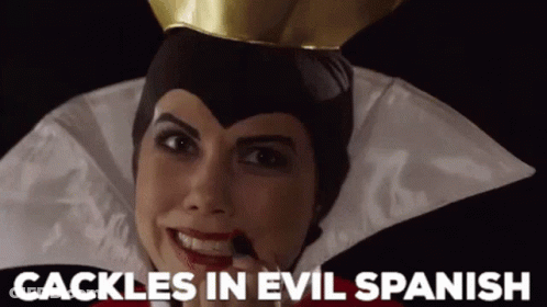A Woman In An Evil Queen Costume With The Words " Cackle In Evil Spanish " Above Her GIF