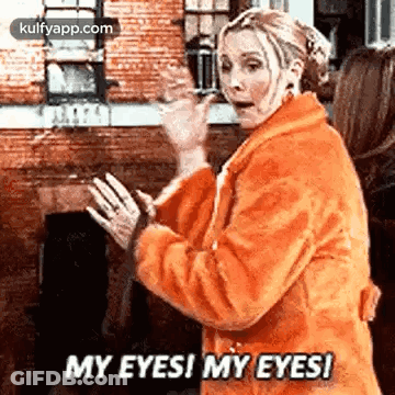 A Woman In An Orange Coat Is Saying `` My Eyes ! My Eyes ! '' . GIF