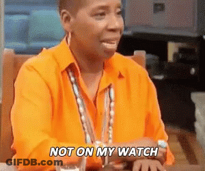 A Woman In An Orange Shirt Is Sitting At A Table With A Glass Of Water And Says `` Not On My Watch '' . GIF