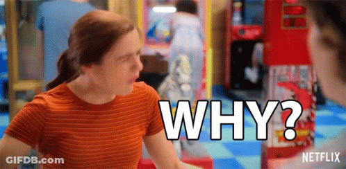 A Woman In An Orange Striped Shirt Is Asking Why In An Arcade . GIF