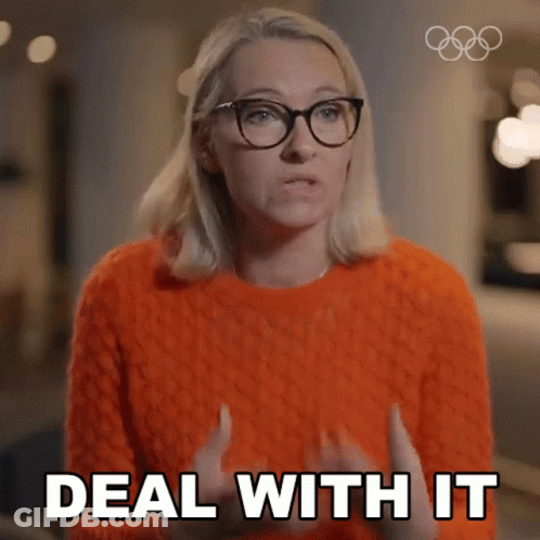 A Woman In An Orange Sweater And Glasses Says Deal With It GIF