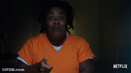 A Woman In An Orange Uniform Is Screaming In A Dark Room With A Netflix Logo In The Corner GIF