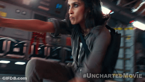 A Woman In An Uncharted Movie Is Sitting On A Plane GIF