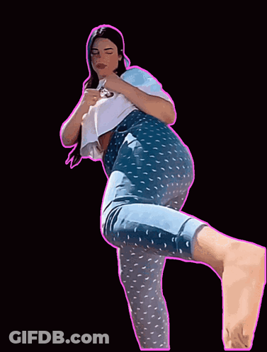 A Woman In Blue Polka Dot Pants And A White Shirt Is Standing On One Leg GIF