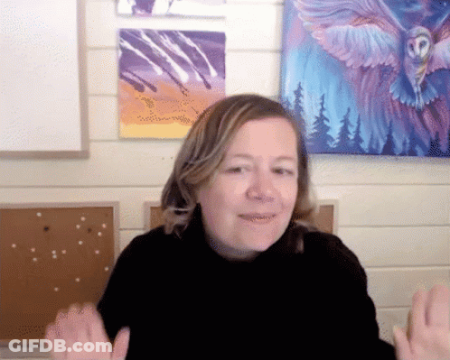A Woman In Front Of A Painting Of An Owl With Wings GIF