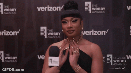 A Woman In Front Of A Wall That Says Verizon On It GIF