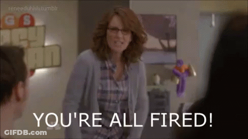A Woman In Glasses Is Standing In Front Of A Group Of People And Says You 'Re All Fired . GIF
