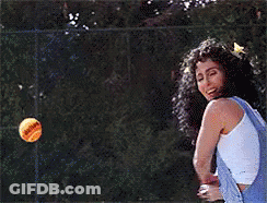 A Woman In Overalls Is Holding A Tennis Ball In Her Hand GIF