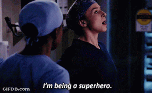 A Woman In Scrubs Says I 'M Being A Superhero Next To A Man In Scrubs GIF
