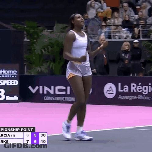 A Woman In Shorts Is Walking On A Tennis Court GIF