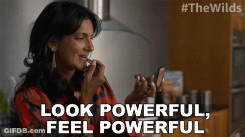A Woman Is Applying Lipstick And The Words Look Powerful Feel Powerful Are Above Her GIF