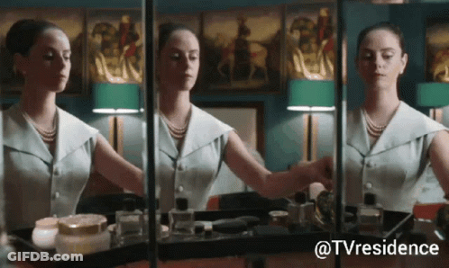 A Woman Is Applying Makeup In Front Of A Mirror With The Hashtag Tvresidence GIF