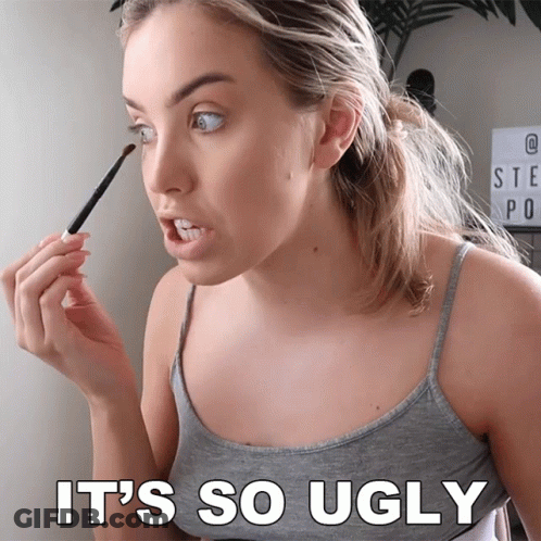 A Woman Is Applying Makeup With The Words It 'S So Ugly Behind Her GIF